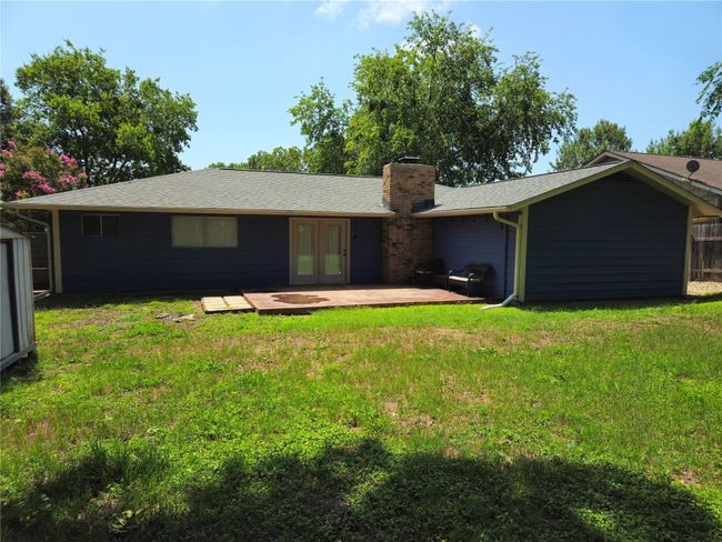 Back of property with french doors, a yard, a patio, and a chimney | Image 21