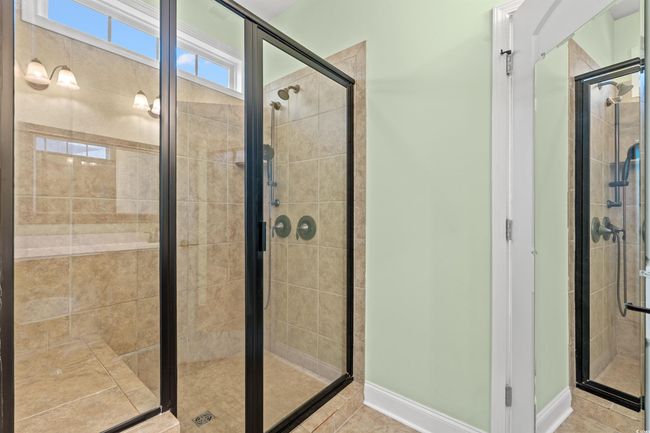 Full bathroom featuring a stall shower, baseboards, and tile patterned flooring | Image 21