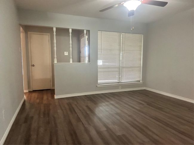 Spare room featuring wood finished floors, ceiling fan, and baseboards | Image 4