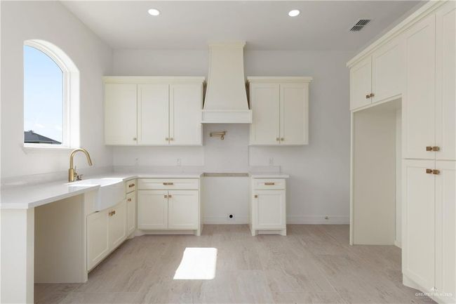 Apartment Living Area with Natural LightOpen living space with tray ceiling, recessed lighting, and multiple arched windows that flood the room with natural light. | Image 30