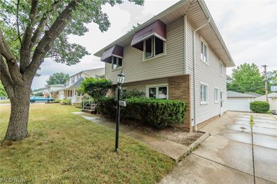 View of front facade featuring a garage, a front lawn, and an outdoor structure | Image 3