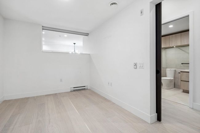 Unfurnished room featuring a baseboard radiator, light wood-style flooring, baseboards, and visible vents | Image 16