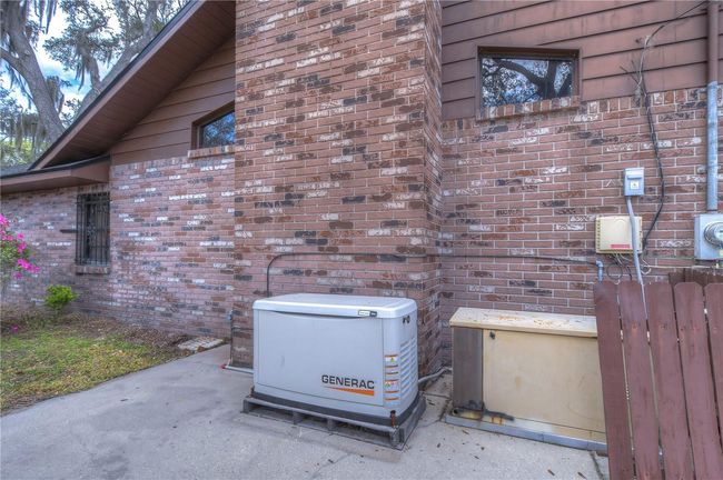 Garage with plenty of cabinet storage! | Image 69
