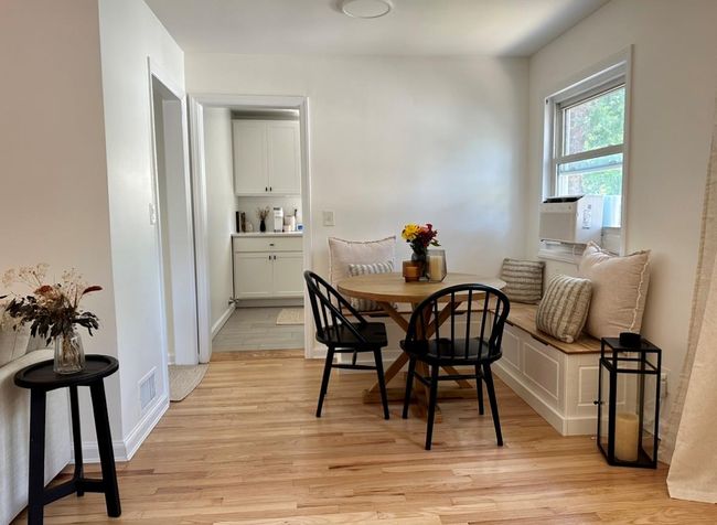 Dining room with light wood-style floors, cooling unit, and baseboards | Image 8