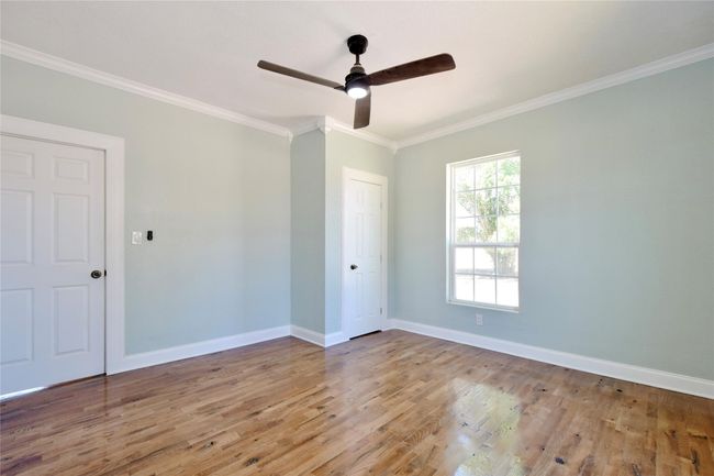 Unfurnished room with wood finished floors, ornamental molding, and a ceiling fan | Image 9