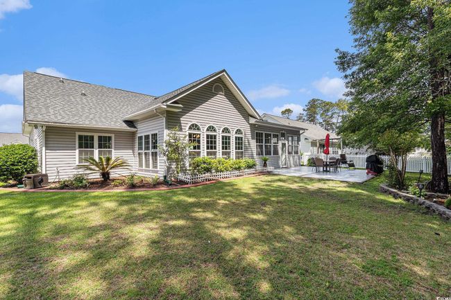 Rear view of house featuring a patio area and a shingled roof | Image 38