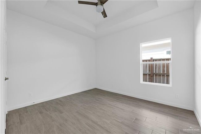 Unfurnished room featuring a tray ceiling and light hardwood / wood-style floors | Image 10