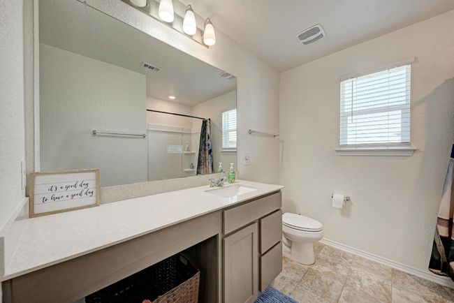 Bathroom with vanity and a shower with shower curtain | Image 28