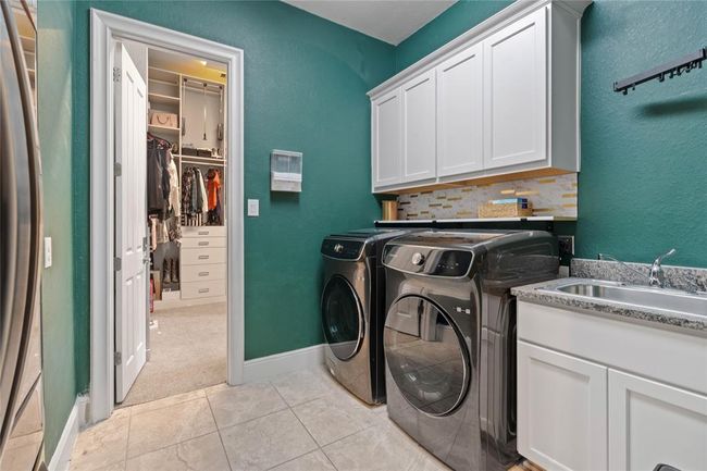 Oversized utility room with passthrough to the one of the primary closets. | Image 17