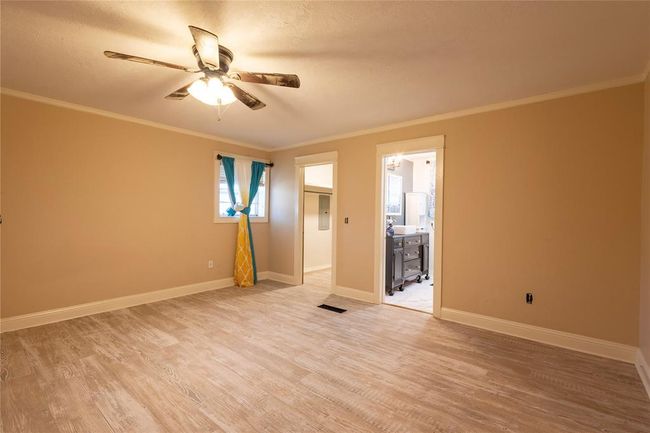 Spare room with light wood-style flooring, ceiling fan, ornamental molding, and baseboards | Image 12
