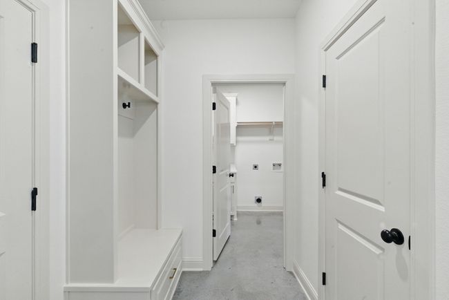 Mudroom with concrete flooring and baseboards | Image 24