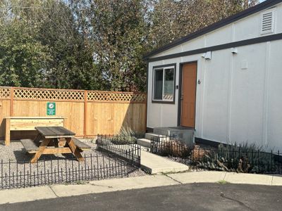 View of front facade, studio unit entrance and landscaped common area. | Image 3