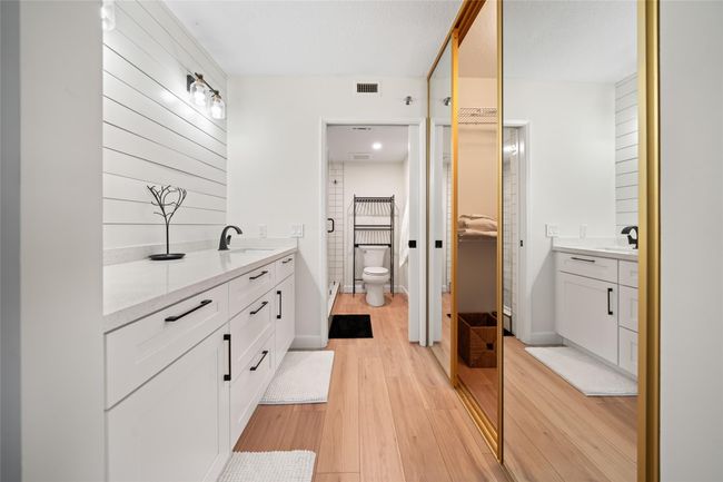 Primary dressing area leading into walk-in closet and bathroom | Image 10