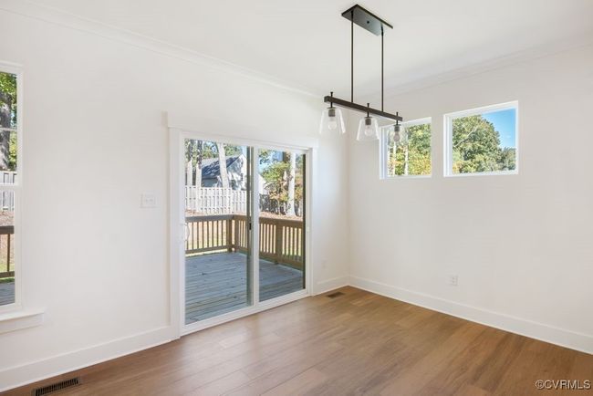 Photo represents the plan, not the actual home. Design selections may vary. A spacious kitchen with an island and pantry open to an adjoining dining area and the family room. | Image 13
