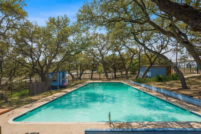 View of swimming pool featuring an outbuilding and fence | Image 36