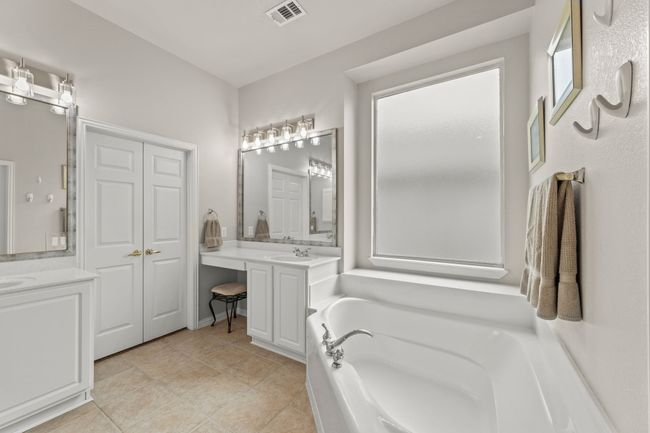 Bathroom featuring a bath, tile patterned flooring, and vanity | Image 31