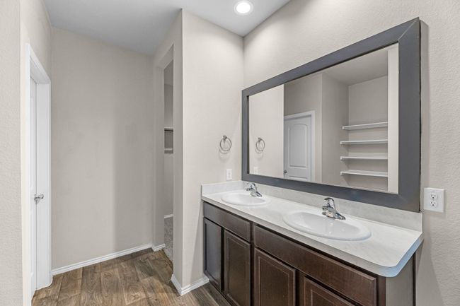 Another view of double sinks and framed mirror in primary bathroom. | Image 32