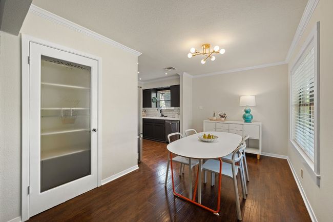 Built-in pantry space elegantly positioned within the kitchen/dining area. | Image 9