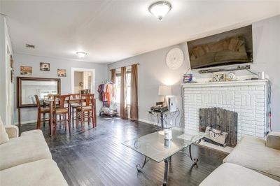 Living room featuring dark hardwood / wood-style floors and a brick fireplace | Image 3