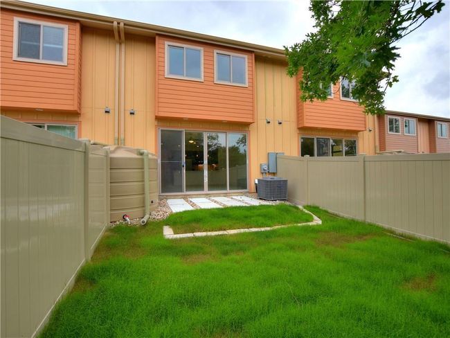 Rear view of property featuring board and batten siding and a fenced backyard | Image 24
