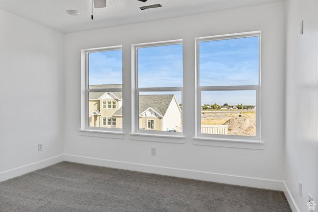 Spare room with baseboards, ceiling fan, and carpet flooring | Image 16