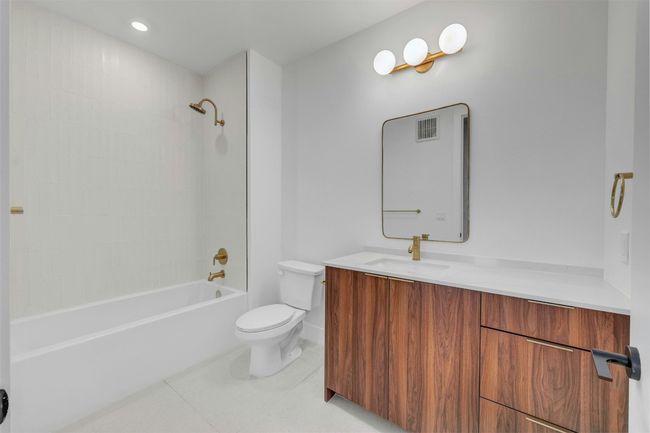 Full bathroom featuring vanity, shower / bath combination, and tile patterned flooring | Image 18