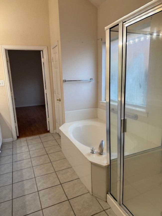 Full bath with tile patterned floors, a bath, and a shower stall | Image 14