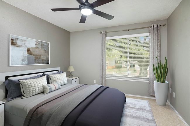 Carpeted bedroom featuring ceiling fan and baseboards | Image 5