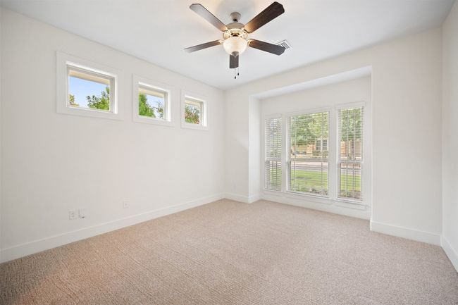 The primary suite sits in its own quiet corner of the home | Image 19