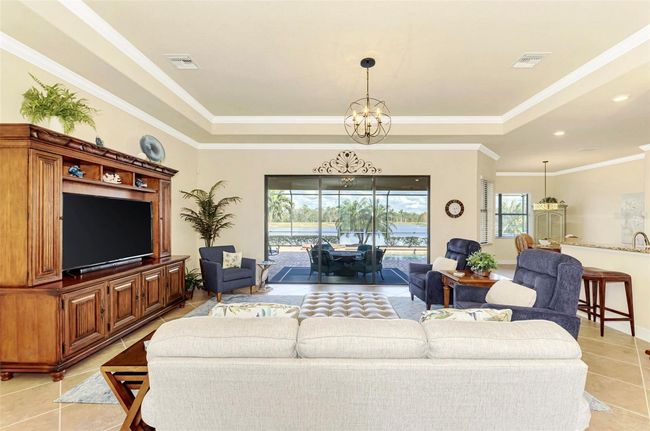 Great Room with Tray Ceiling and Crown Molding w/Tile Floors | Image 17