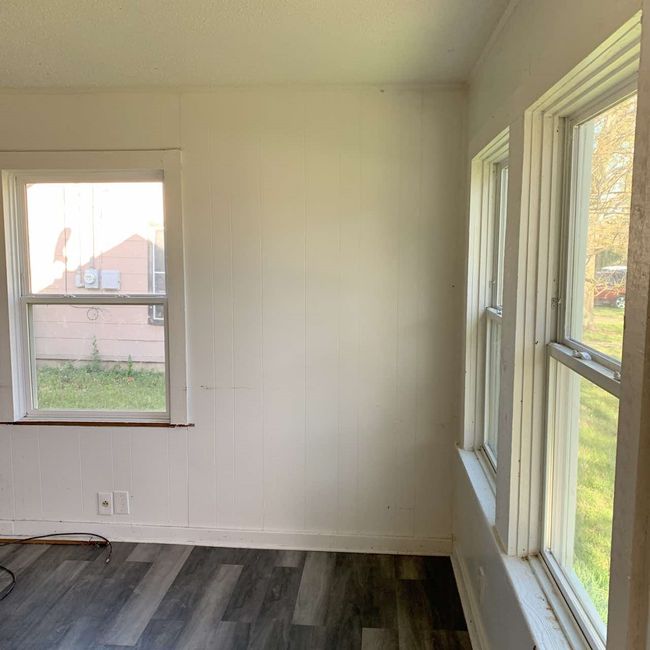 Spare room featuring plenty of natural light and wood finished floors | Image 6