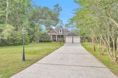 All brick charming home with 4 bedrooms, 2.5 baths plus game room. Home sits back from road and has 2 decorative electric light posts. | Image 1