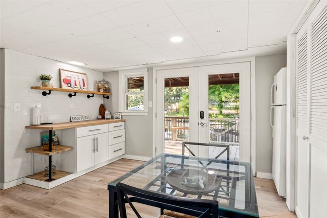 Guest house dining and kitchen area with refrigerator and bar area plumbed for sink | Image 16