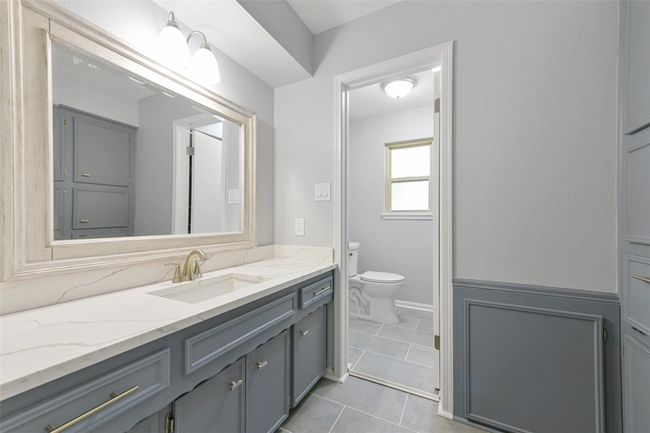 Full bath upstairs with built in cabinets behind & separate door to commode & shower | Image 25