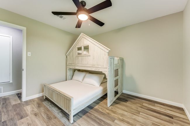 Bedroom featuring light wood-type flooring and a ceiling fan | Image 23