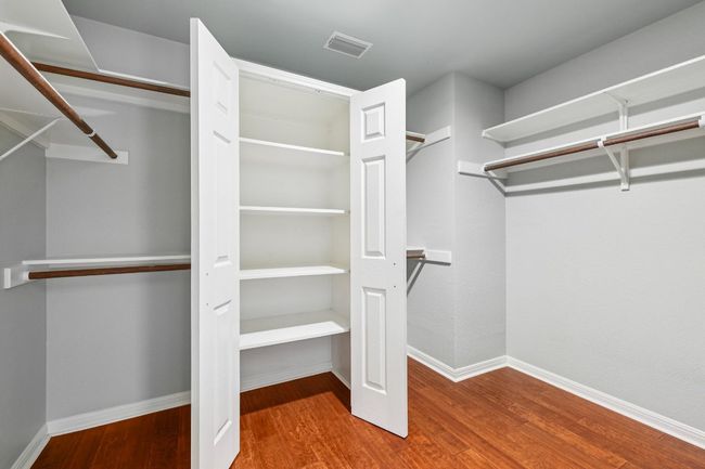 A large walk-in closet provides abundant storage and organization. | Image 21