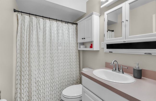 Full bath with vanity, toilet, and a shower with curtain | Image 17