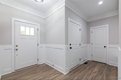 Foyer entrance with dark wood-type flooring and crown molding | Image 2