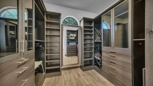 Spacious closet with light wood finished floors | Image 25