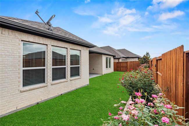 With a full sprinkler system already in place, this backyard offers just the right amount of space for a vibrant garden and room for your family pets to play, low-maintenance, secure, and ready to enjoy. | Image 40