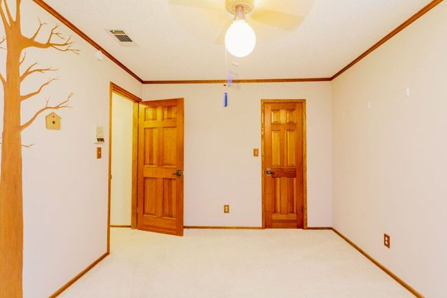 Carpeted spare room featuring crown molding and ceiling fan | Image 6