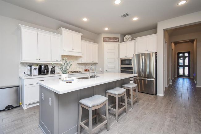 This photo shows the beautiful kitchen and grand entry. | Image 12