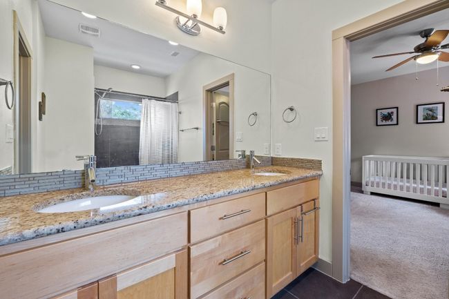 Full bathroom featuring tile patterned floors, double vanity, a sink, and visible vents | Image 20
