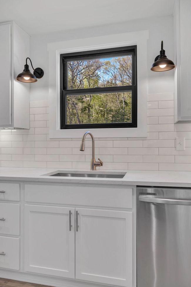 Beautiful kitchen sink area with a great view of the back yard. | Image 15