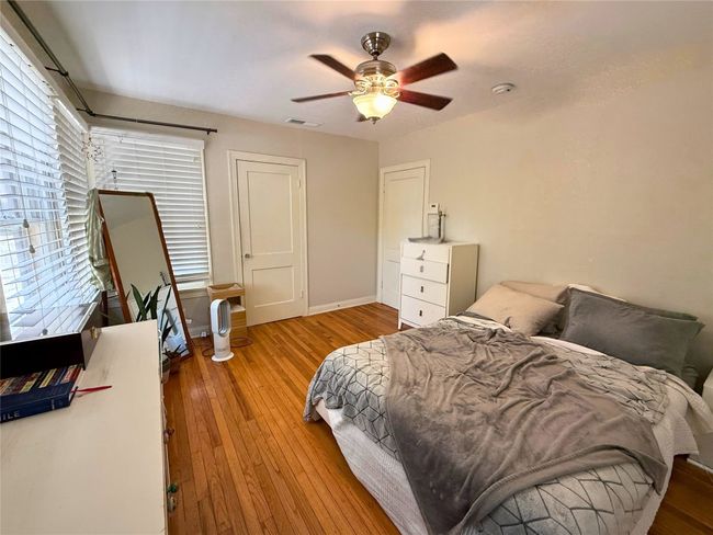 Bedroom with multiple windows, hardwood / wood-style floors, and ceiling fan | Image 13