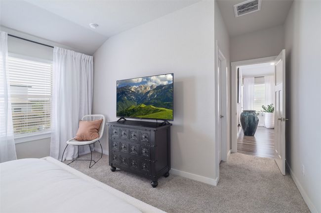 Primary Bedroom featuring light carpet and ceiling fan. | Image 17