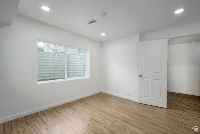 Basement bedroom with recessed lighting, visible vents, baseboards, and wood finished floors | Image 25