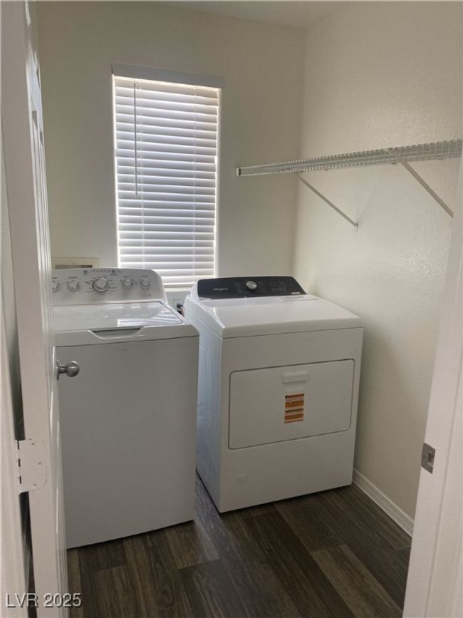Clothes washing area with dark wood finished floors, baseboards, separate washer and dryer, and laundry area | Image 13