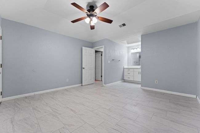 Unfurnished bedroom featuring ensuite bath and a ceiling fan | Image 24