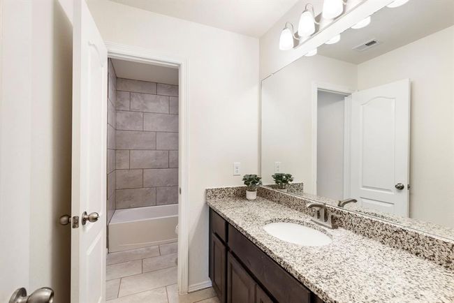 The secondary full bathroom upstairs features ample countertop space & has a privacy door from the tub/shower, making getting ready in the morning more convenient. | Image 35